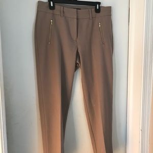 Tan slacks with gold zipper pockets